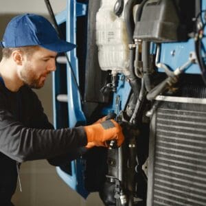 Technician performing routine maintenance on outdoor AC unit